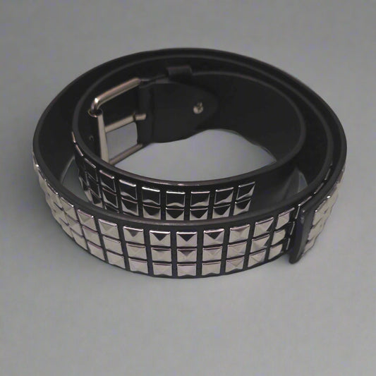 Black belt with silver studs on a gray surface