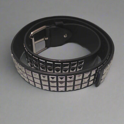 Black belt with silver studs on a gray surface